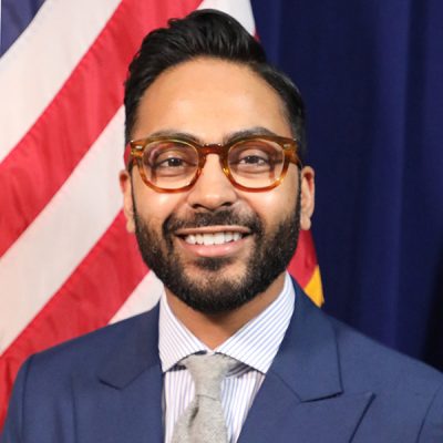 A person smiles while posing for a headshot.