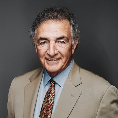 A person smiles while posing for a headshot.