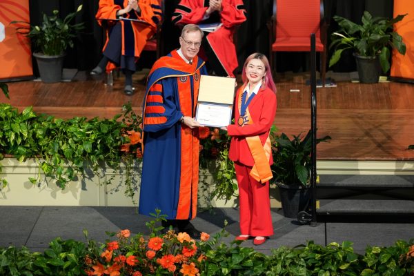 Qingyang Liu receives Chancellor's Citation from Chancellor Kent Syverud at the One University Awards