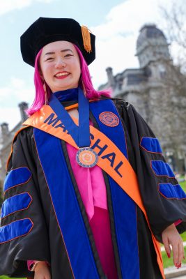 Qingyang Liu in Commencement regalia in front of the Hall of Languages