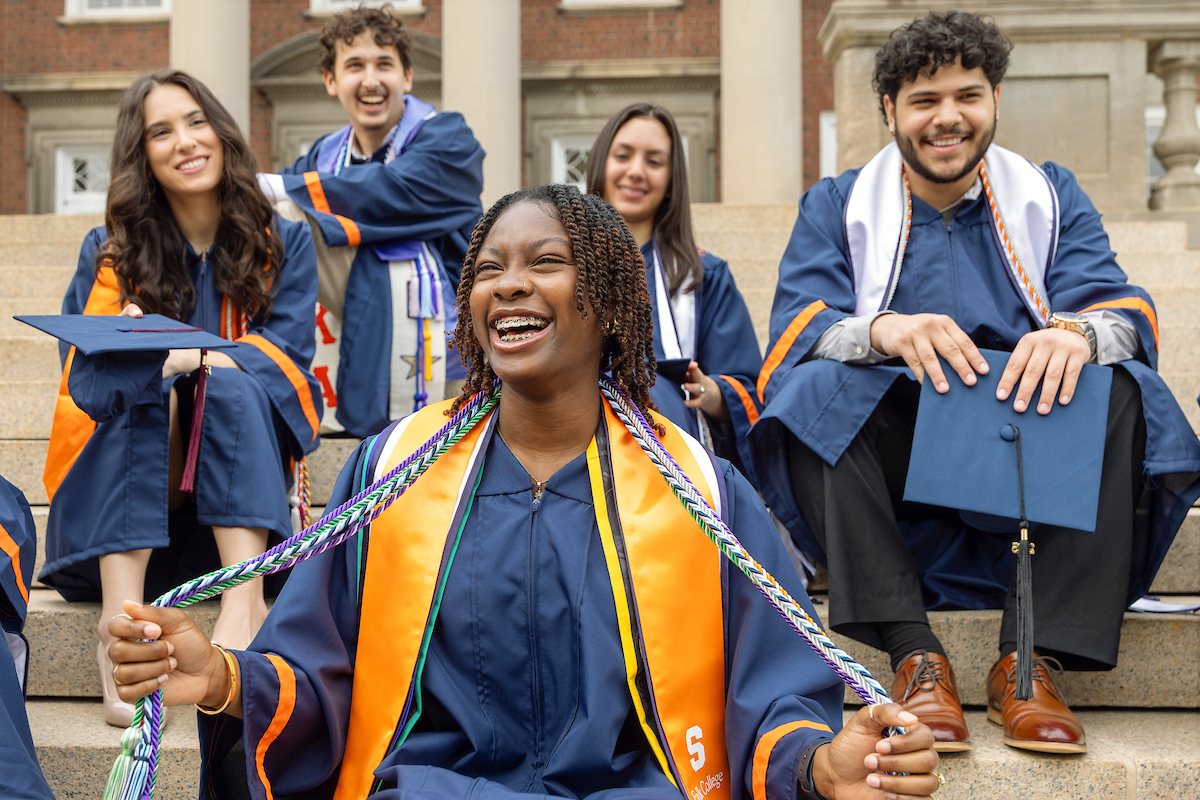 group of people in academic regalia on the steps of Hendricks Chapel