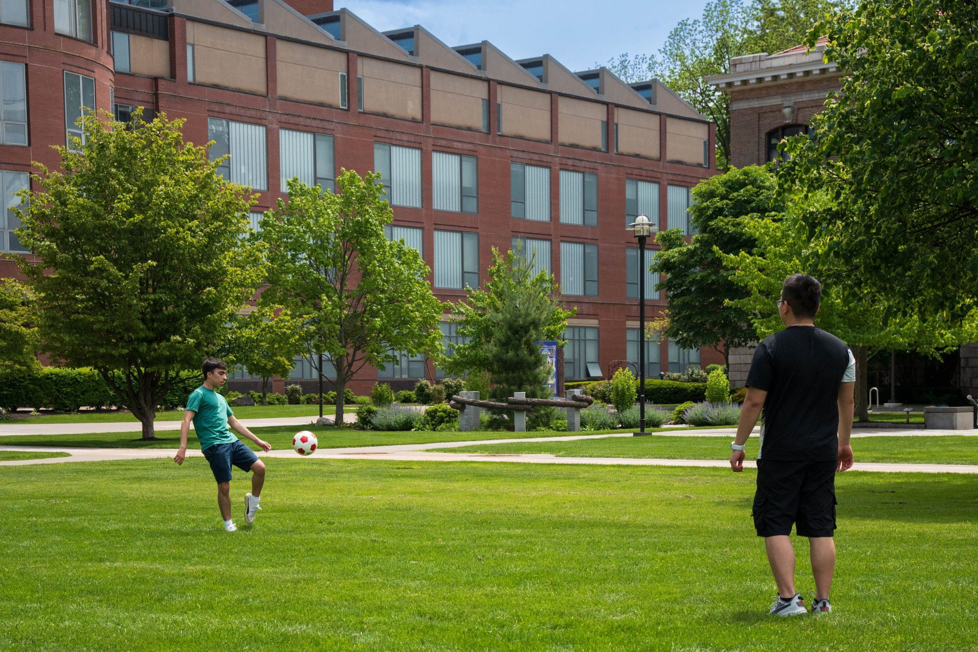 Students playing soccer on the Kenneth A. Shaw Quad