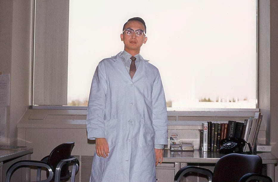person standing in front of window wearing lab coat