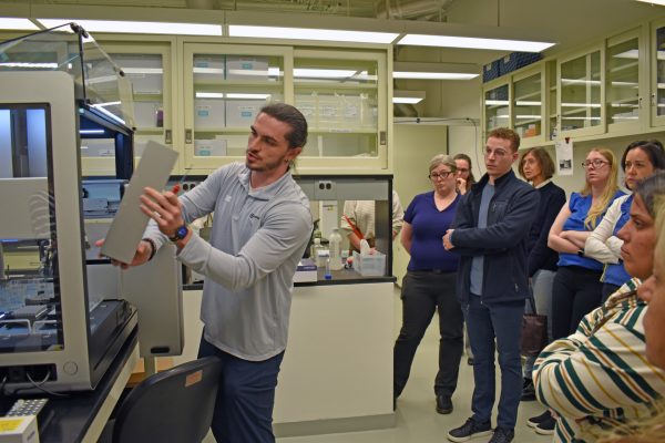Zach Galluzzo, a field application scientist with Opentrons, provides a demonstration of an NGS workstation, which automates the preparation of DNA sequencing samples.