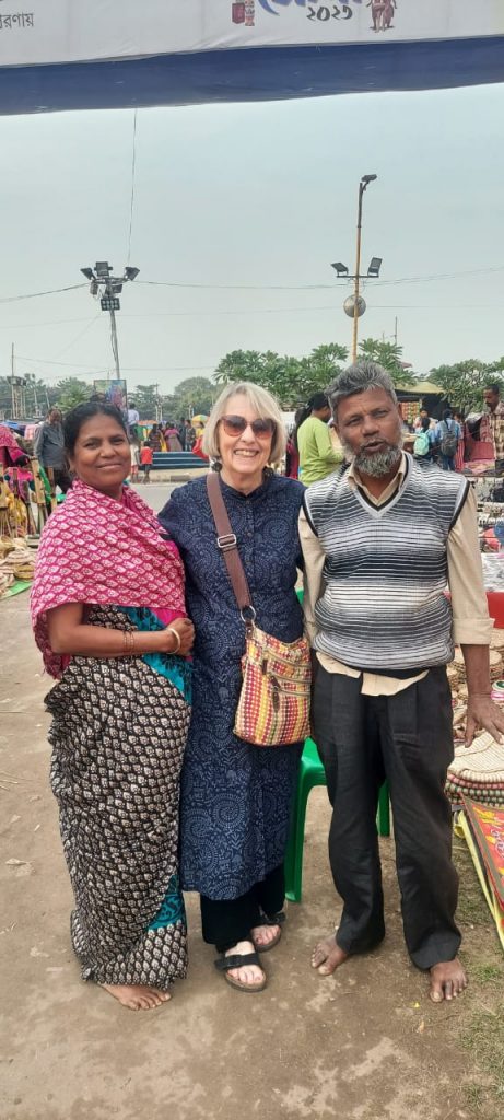 Two women and a man standing together in India