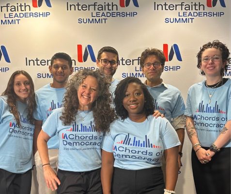 Hendricks Chapel participants at Interfaith Leadership Summit; three men and four women, each wearing a light blue Chords of Democracy t-shirt