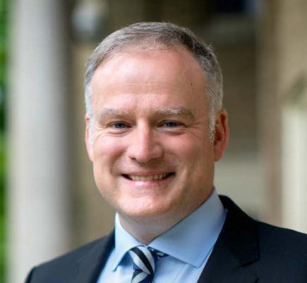 John Cawley, man in blue jacket, blue shirt and blue striped tie