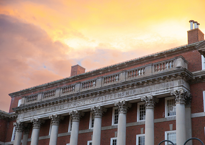 Maxwell School building with brightly lit clouds in the background