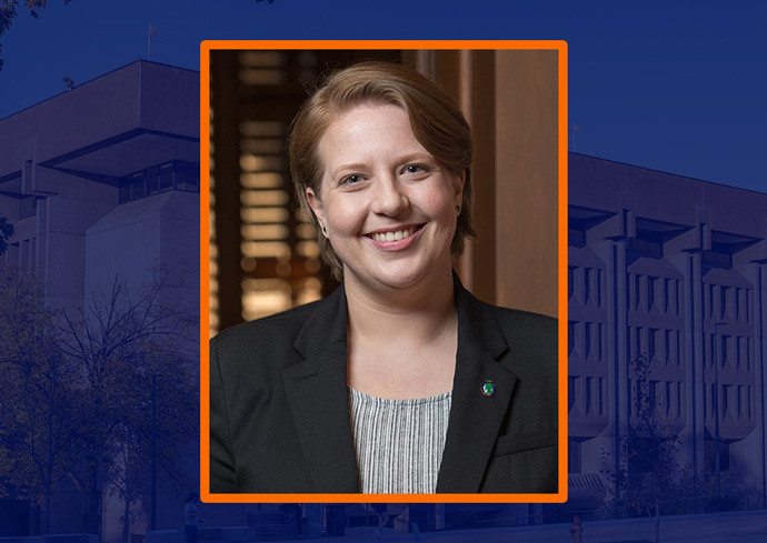 Headshot of a person in a black blazer and striped shirt with an orange border over a photo of Bird Library with a translucent blue filter applied