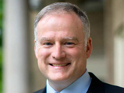 John Cawley, man in blue jacket, blue shirt and blue striped tie