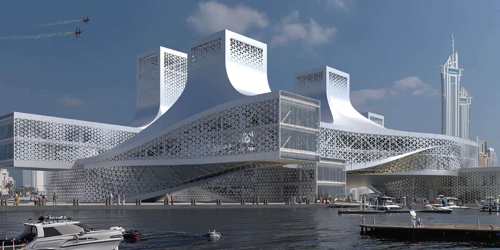 Steel lattice building by waterfront with boats, two planes overhead and a skyscraper in the background.