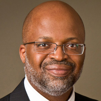 A person poses for a headshot indoors.