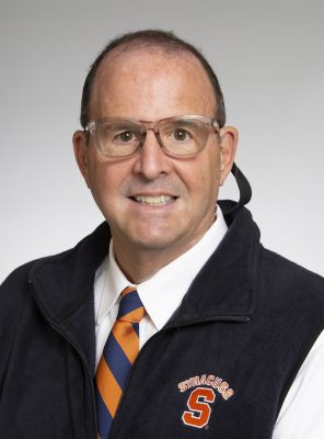 Person in glasses and Syracuse University vest with orange-blue striped tie.
