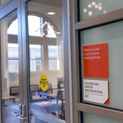Glass doors leading to the Counseling Center waiting room, with signs reading “Mary Lou and Louis Carona Waiting Room” and “Counseling Center Waiting Room 302.”