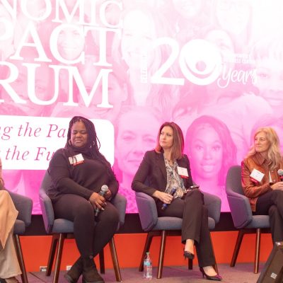Five speakers seated on a stage.