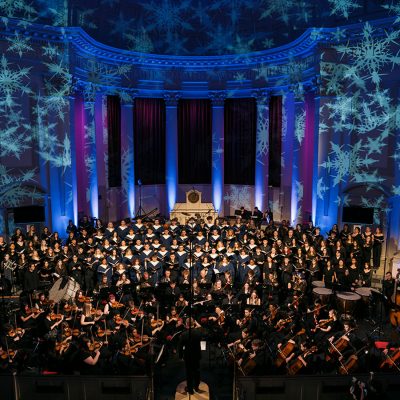 Musicians perform during Holidays at Hendricks in 2024. Snowflakes are projected on the ceiling of Hendricks Chapel