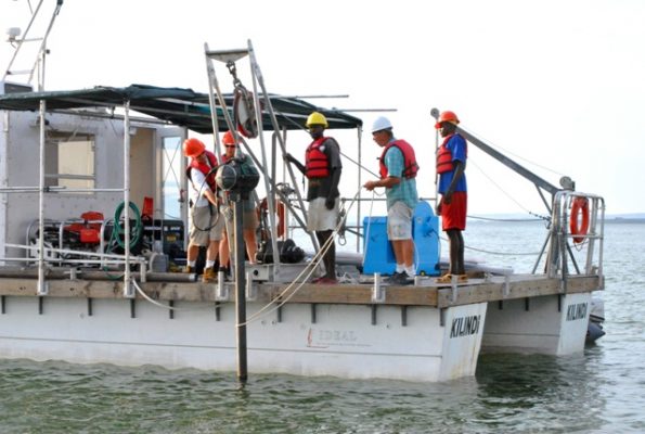 Research team members prepare equipment on the deck of a vessel during a field study expedition.
