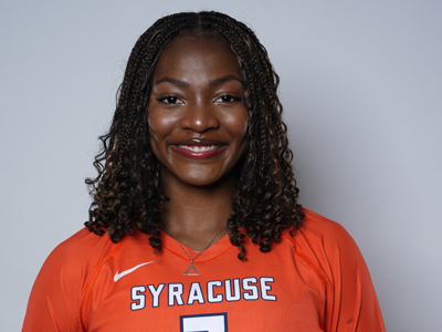 A person smiles while wearing their orange Syracuse women's volleyball jersey.