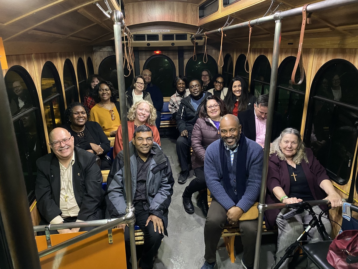 group of people seated on a trolley