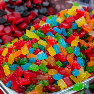 Brightly colored gummy candies in display bins