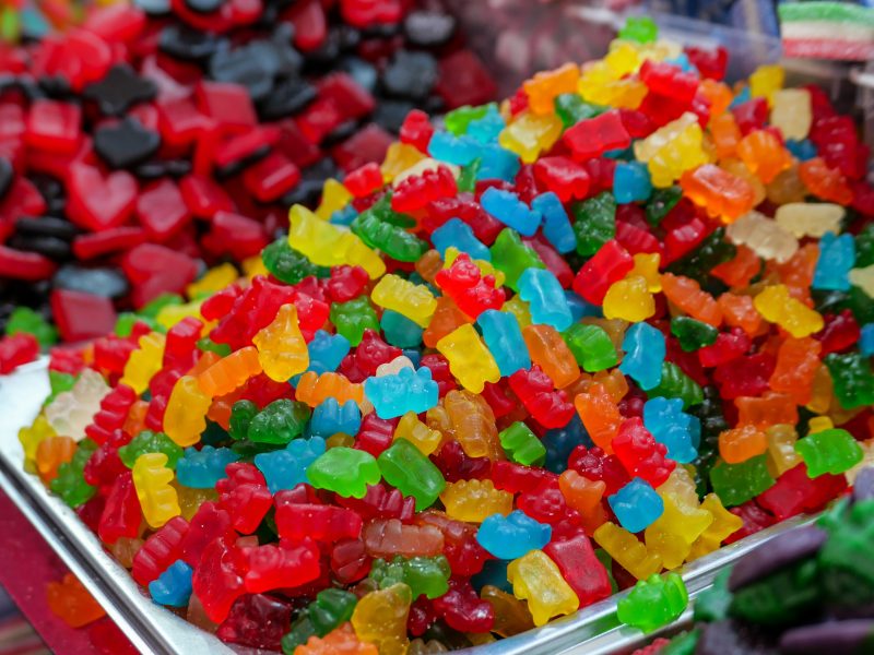 Brightly colored gummy candies in display bins