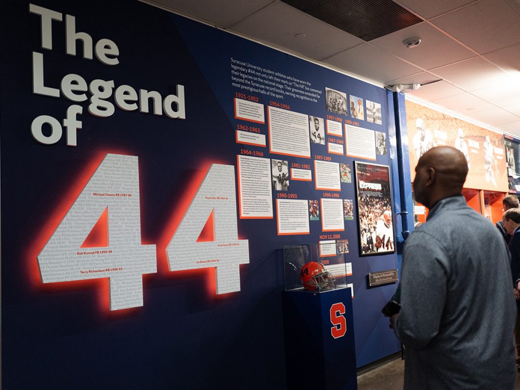 A person looks at the Legend of 44 exhibit. A large 44 is prominently featured.