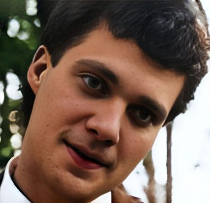 Photo of a man with dark hair and smiling