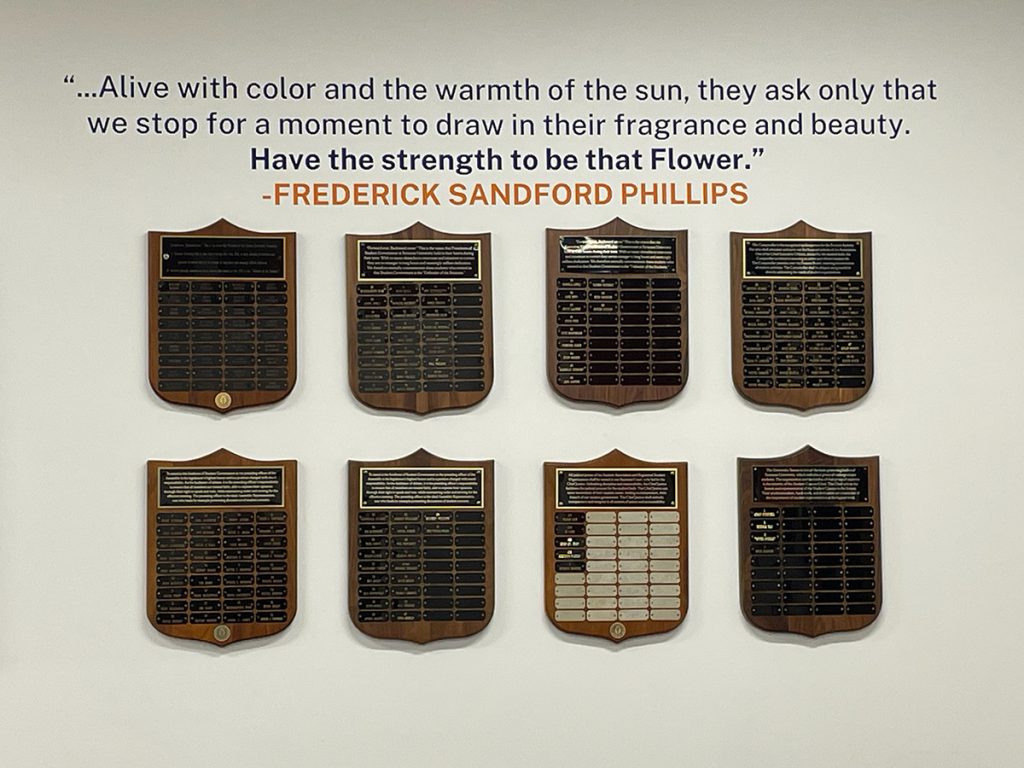 Wall with a quote from Sandy Phillips and plaques