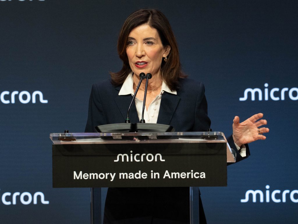 A person delivers remarks while standing at a podium.