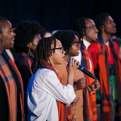 Singers in colorful attire perform at the 2025 MLK celebration.