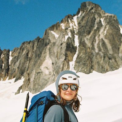 Woman in ski gear is pictured in front of a mountain