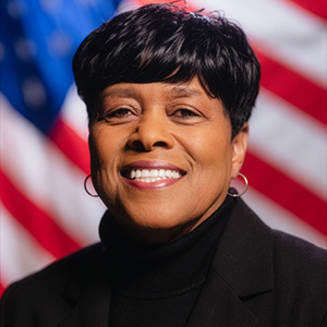 Syracuse Mayor Sharon Owens, with an American flag in the background