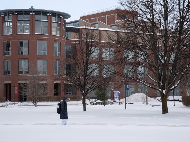 A student crosses a snow-covered campus.