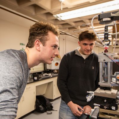Two students work in a lab