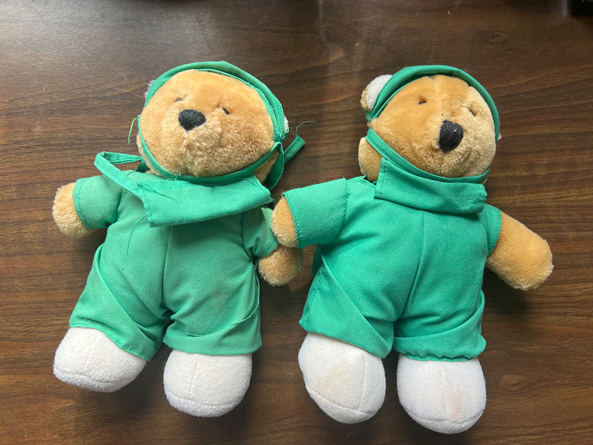 Teddy bears dressed in green doctors' scrubs