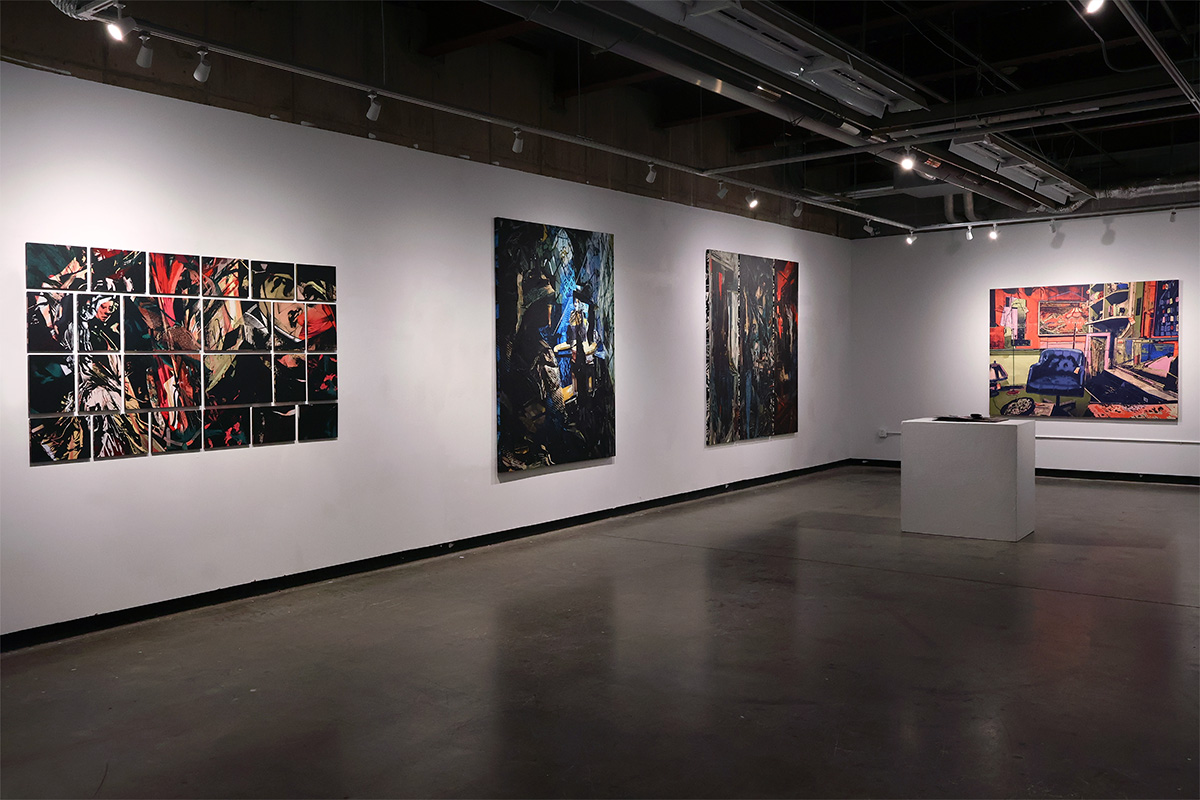 Artwork mounted on white gallery walls.