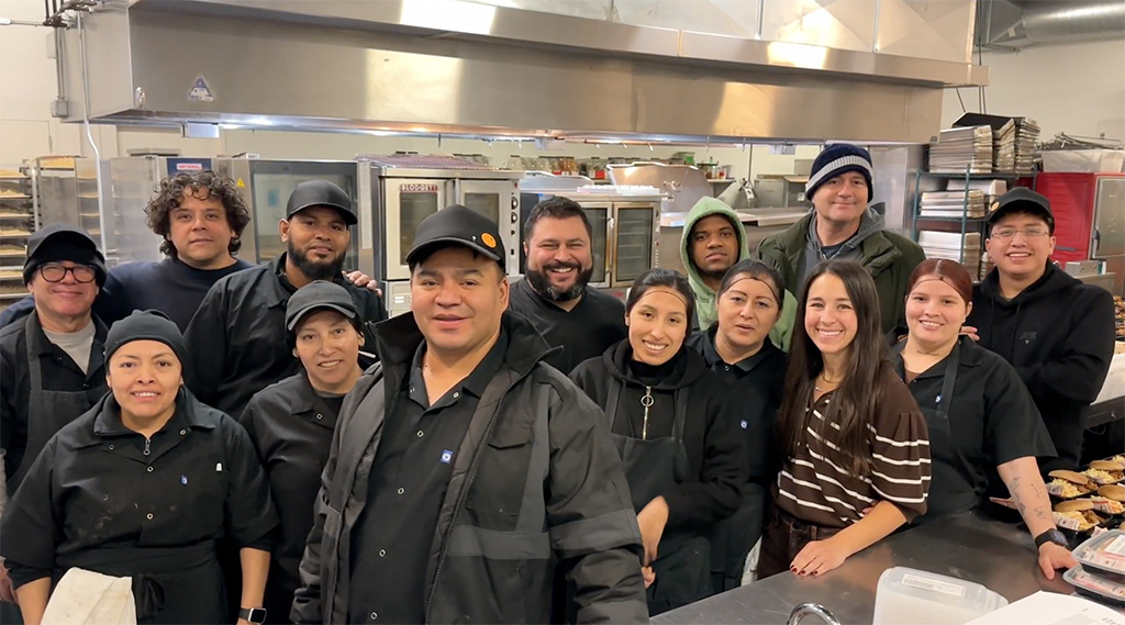 Culinary team members are pictured in a kitchen setting.