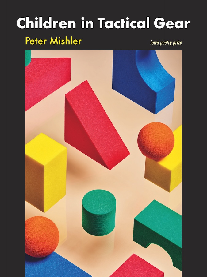 A cover featuring colorful geometric foam shapes—blocks, cylinders, arches—arranged across a soft beige surface.
