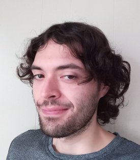 A person smiles for a headshot.