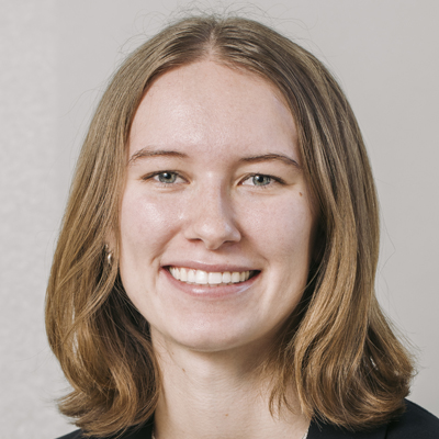 A person smiles while posing for a headshot.