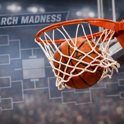 Basketball going through hoop with brackets in background