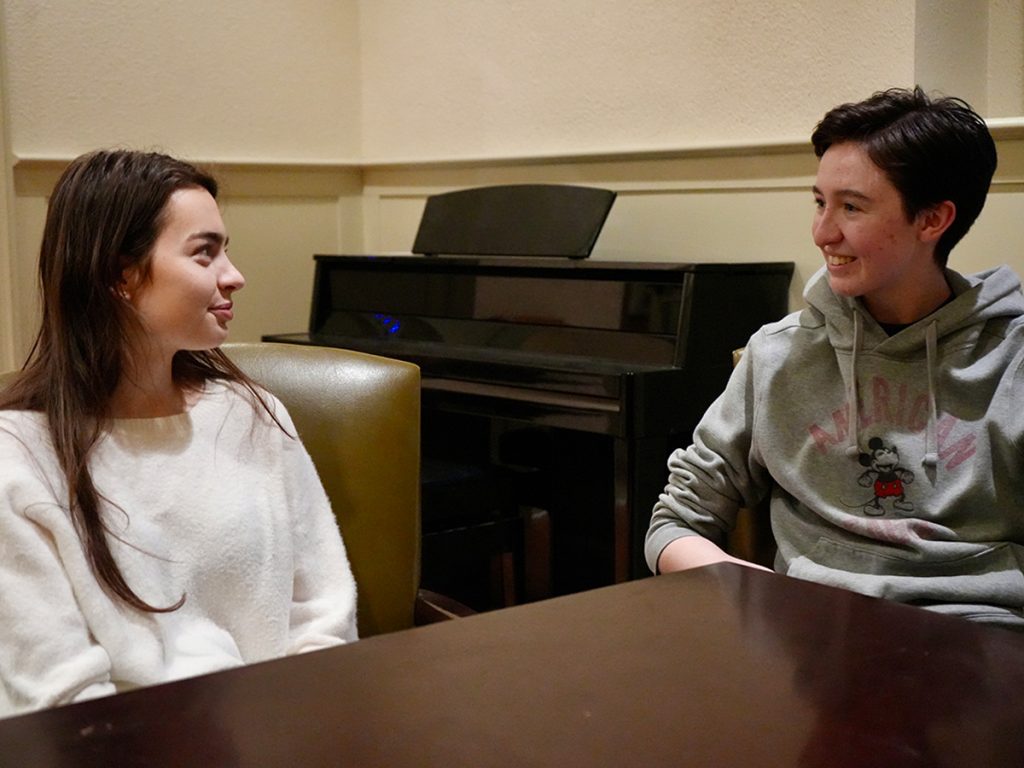 Two women sitting at a table talking