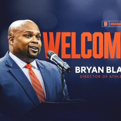 A graphic welcoming Bryan Blair as Syracuse University's new director of athletics, featuring Blair speaking at a podium against a dark blue background, with the word "WELCOME" in large orange letters and the Syracuse Orange and Nike logos in the upper right corner.