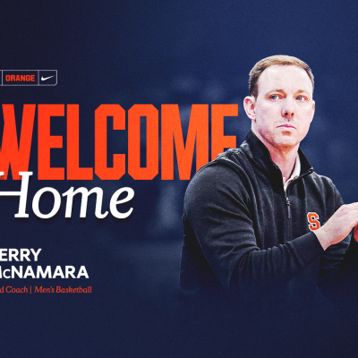 Gerry McNamara claps while wearing a dark Syracuse pullover, alongside bold "Welcome Home" text and his title, Head Coach, Men's Basketball, on a navy blue background with Syracuse Orange and Nike branding.