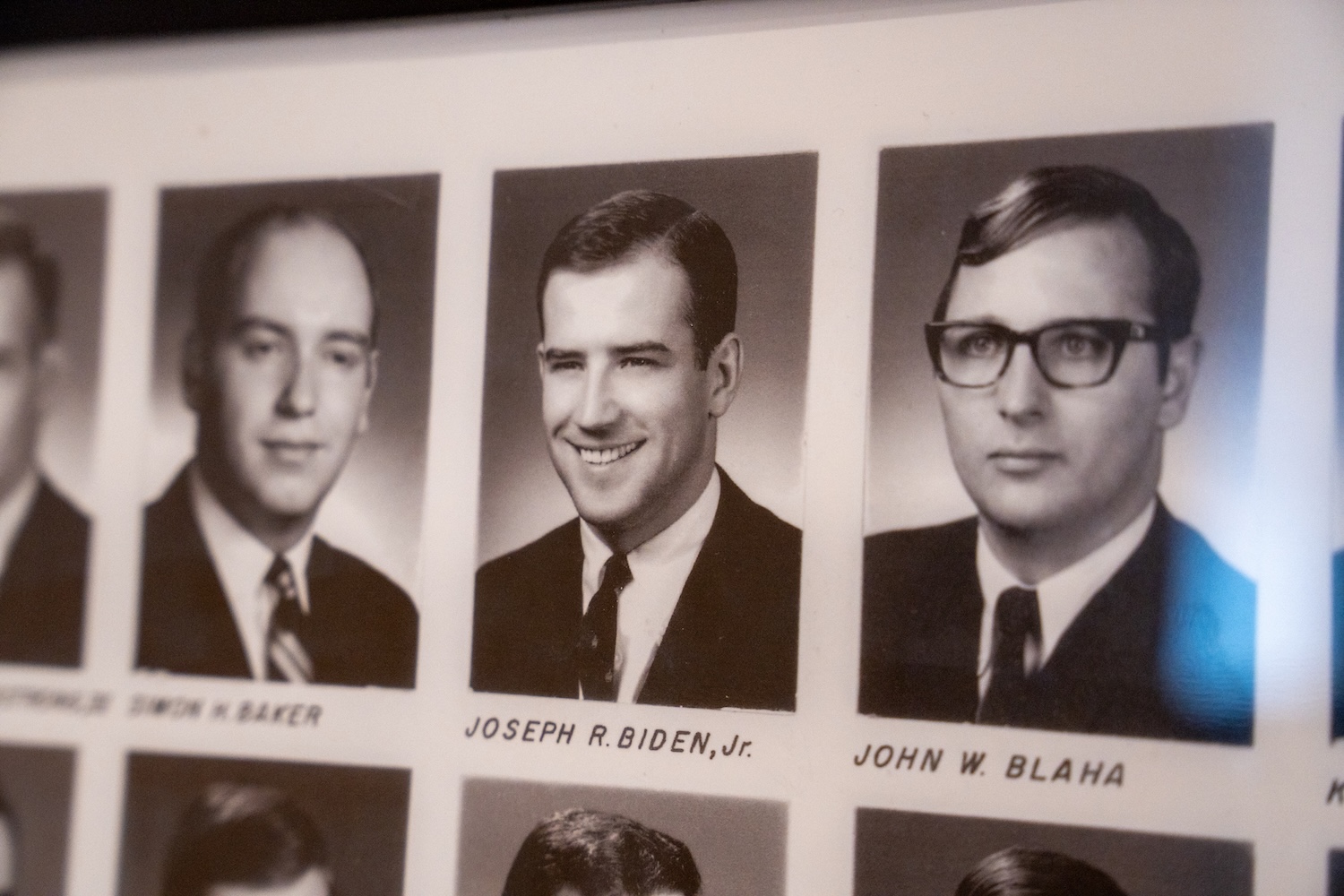 Black-and-white yearbook portraits, including one labeled “Joseph R. Biden, Jr.,” displayed in a framed page.