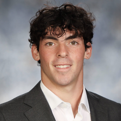 A student smiles while posing for a headshot.