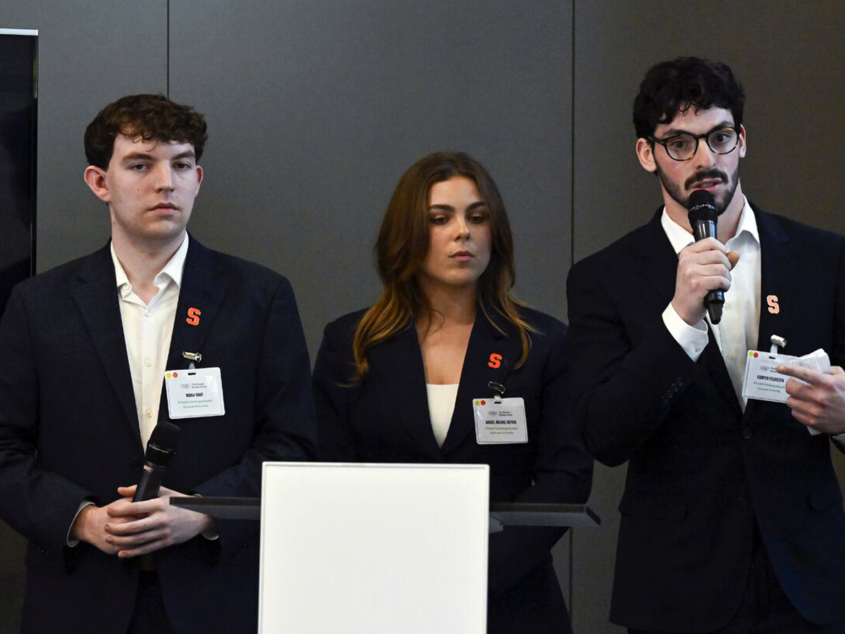 Three students answer a question during a presentation at the Olympic Museum.