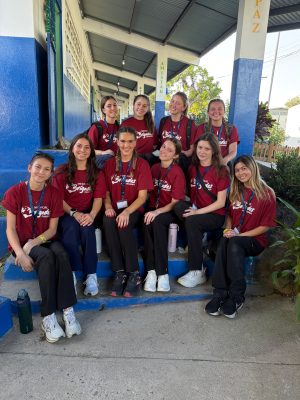A group of Global Medical Brigades student volunteers poses on steps outside a building in Panama.