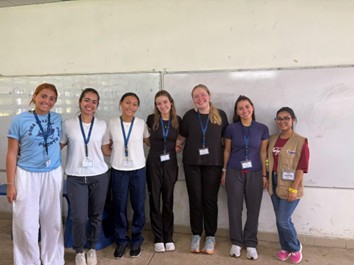 Seven women pose together inside a classroom during a Global Medical Brigades community health research session in Panama.