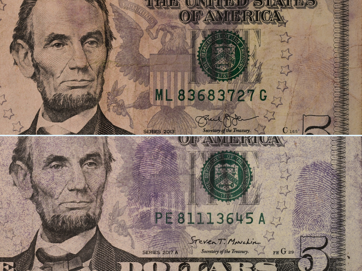 Two $5 bills side by side showing latent fingerprints revealed through chemical processing on U.S. currency.